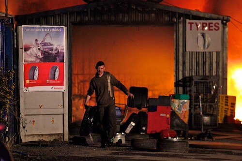Moving tyres at the scene of a major fire at Newry Road, Mayobridge, County Down on Sunday night. Picture: Columba O'Hare