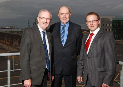 Minister for Regional Development Danny Kennedy MLA congratulates partners John MacMahon and John McGinn on the launch of John MacMahon & Co Chartered Accountants Belfast office.