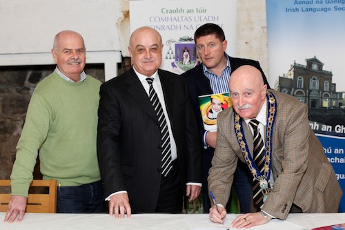 Mayor Charlie Casey signing the Memorandum of Understanding for the Gaeláras Mhic Ardghail project along with, from left: Seámas MacDhaibhéid, Trustee; Gerard Trainor, Chair of the Gaeláras Mhic Ardghail Charitable Trust and Caoimhín MacGiolla Mhín, Director of Ciste In Fheistíochta Gaeilge. Picture: Columba O'Hare