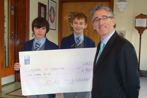 Two Junior St Colman's students presenting the cheque for £900 to Mr McKinney, Principal of St. Colman’s