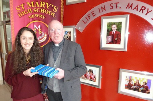 Head Girl Judith Mc Cartan presents Bishop Mc Areavey with a gift