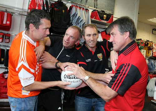 Pictured at the launch of the 'Clash of the Titans' GAA Legends Charity Football Match in Ballyholland on Saturday 21st August at 6pm were long time rivals Oisin McConville and Brendan McKernan held back by Mickey Linden and organiser Paul Coulter, for more action and rivalry on the pitch support this fundraiser in aid of Southern Area Hospice