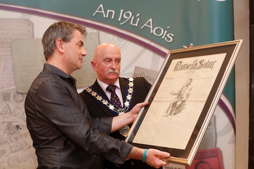 Séimí MacAindreasa, Pobal and Cllr Charlie Casey, Mayor, Newry and Mourne District Council look over one of the old Irish Language newspapers on show at the Library launch of  Súil Charad an exhibition of Irish language community publications from the 18th Century to the present day. . Photo: Columba O'Hare