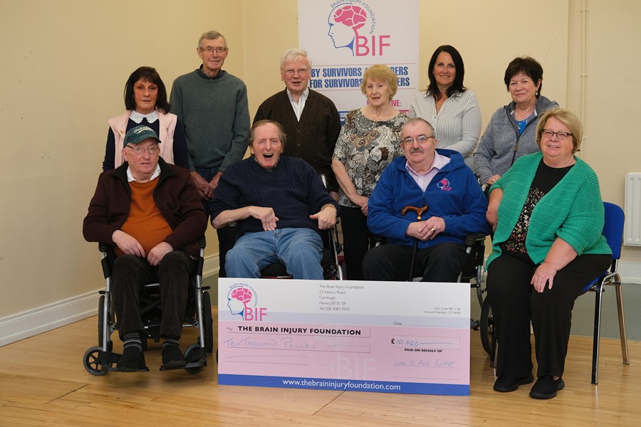 Pictured seated from left are: Patrick Rooney, survivor from Newry, Sean Calvey, survivor from Meigh, Mel McDermott, survivor from Camlough, Mary Corry, Chair, Love is for Life Trust Standing from left: Bronach Rooney, carer and Chair of the Brain Injury Foundation, Tom O’Hanlon, carer, Meigh, Fr Johnny Doherty, Director, Love is for Life Trust, Alice O’ Hanlon, carer, Meigh, Olive Hawthorne, Manager, Brain Injury Foundation, Jeanette McDermott, carer, Camlough