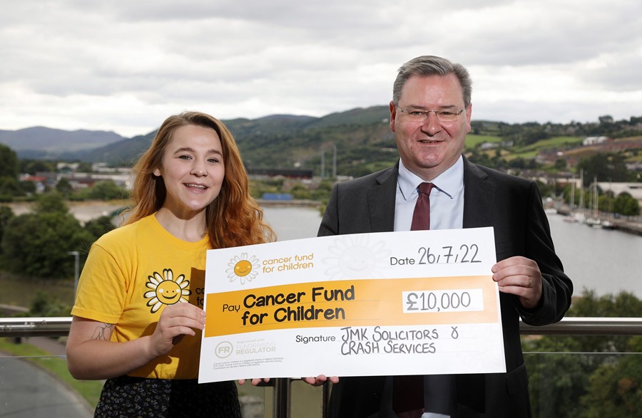 Jonathan McKeown, Chairman of JMK Solicitors and CEO at CRASH presents a cheque for £10,000 to Alex Murdock, Corporate Fundraiser at Cancer Fund for Children.