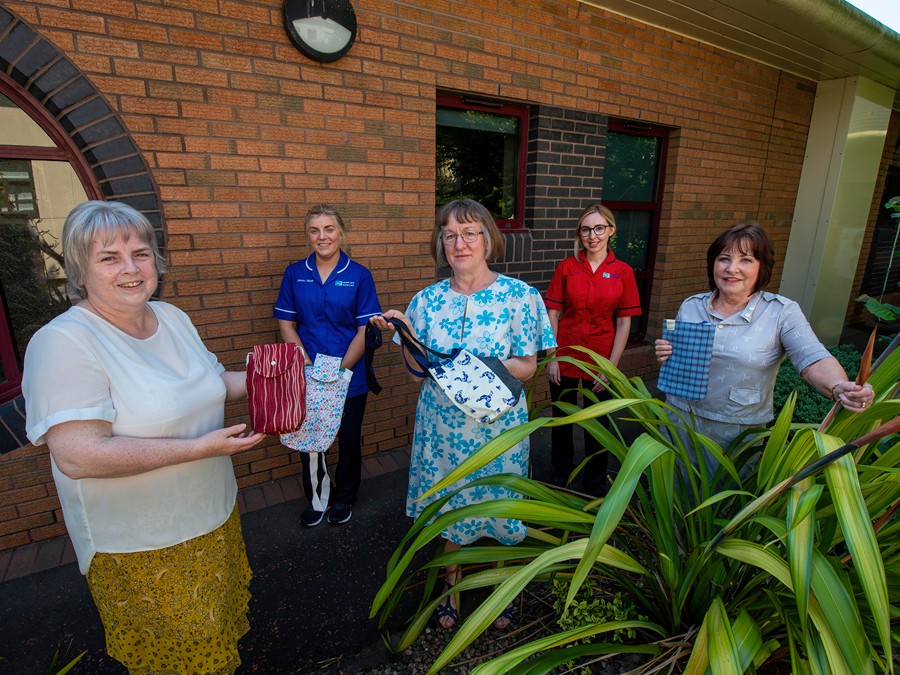 Lislea Sewing group members Mary O’Connor and Mary Murphy (who both retired from the Southern Health and Social Care Trust last year) and Geraldine Johnstone (who currently works as a Bank Health Care Assistant) are pictured donating the bags to Claire O’Connor, Clinical Sister and Amy Ward, Unit Manager.
