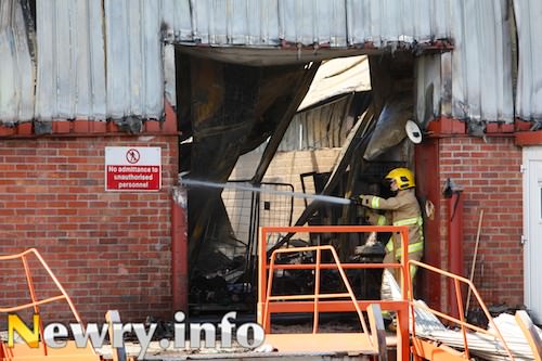 A firefighter works on the fire at a factory close to Cloughoge near Newry. Picture: Columba O'Hare