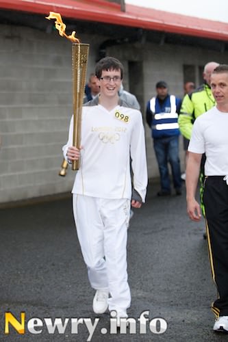 Ryan Cinnamond brings the Olympic Flame into Pairc Esler. Picture: Columba O'Hare