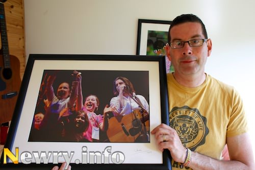 Columba O'Hare with a photograph taken of Brian Kennedy and fans at the Newry City Concert in 2002