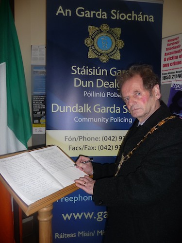 John McArdle, Mayor signs the Book of Condolence for Garda Adrian Donohue at Dundalk Garda Station.