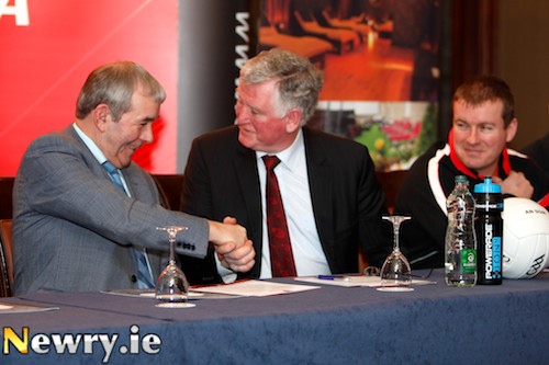 John McParland, Canal Court Hotel and Spa and Seamus Walsh, Chairman, Down GAA County Board shake hands on the new three year Sponsorship deal while Senior football manager James McCartan looks on. Photograph: Columba O'Hare