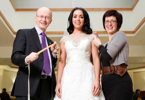 Peter Murray, Buttercrane Centre Manager ensures Buttercrane’s forthcoming Wedding Fayre measures up to the high expectations of bride-to-be Rosalind Mackin from Newry, with the help of some finishing touches from Sharon Patterson, owner of Elody (Bridge Street, Newry), one of the shops who will be exhibiting in the fashion shows.  Rosalind will be getting married in May 2014 and is looking forward to the array of ideas and inspiration that will be on offer at Buttercrane’s Wedding Fayre on Saturday 13 April.