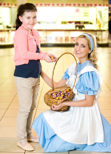 Emma Rafferty, from Poyntzpass is pictured receiving a chocolate egg from Alice in Wonderland, aka Newry’s Catherine McCormack in Buttercrane Centre.  Alice in Wonderland and friends will be stepping through the looking glass and into a world of fashion and wonderment at Buttercrane on Easter Saturday
