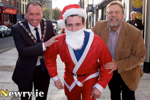 Kevin Rice from Around a Pound, Hill Street gets an early send off for the Santa Fun Run from Newry and Mourne Mayor, Michael Ruane and Jack Murphy, Chairman, Newry City Centre Management. Photograph: Columba O'Hare