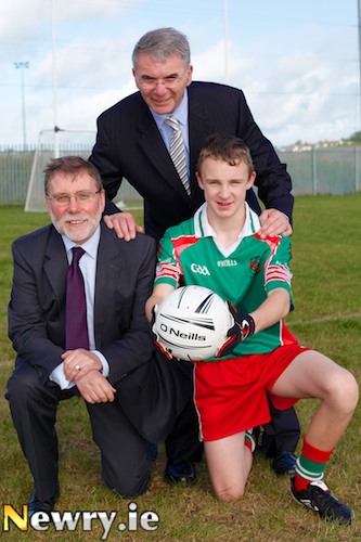 Social Development Minister Nelson McCausland with footballer, Niall Fegan and St Joseph's Principal Hugh Mallon at the official opening of the school's new Football Pitch. Photograph: Columba O'Hare