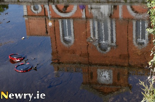 Wreaths from Newry Cenotaph lying in the Clanrye River. Photograph: Columba O'Hare