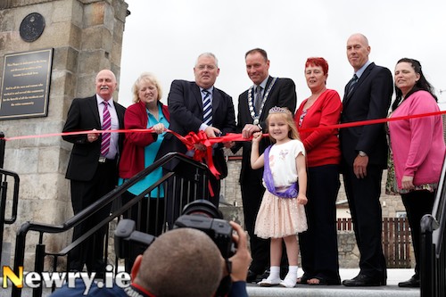 Re-Opening the Linenhall Arch in Newry after it's recent restoration. From left: Cllr Charlie Casey, Elizabeth Casey, Jerome Burns, Deputy Director, Department for Social Development; Cllr Mickey Ruane, Mayor, Newry and Mourne District Council; Ellie Casey, Noreen Rice, Chairperson, Neighbourhood Renewal; Jan Sweeney, NIHE and Kathleen Lowry, Greater Linenhall Community Association. Photograph: Columba O'Hare