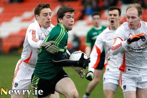 Queen's Shay McArdle from Burren under pressure from Armagh's Charlie Vernon at the Power NI Dr McKenna Cup opener at the Athletic Grounds. Photograph: Columba O'Hare