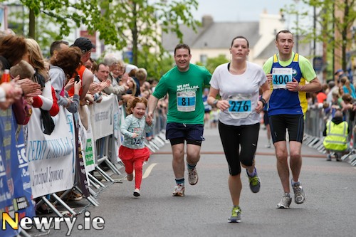 A little help for dad in the home straight of the Newry City Half Marathon. Photograph: Columba O'Hare