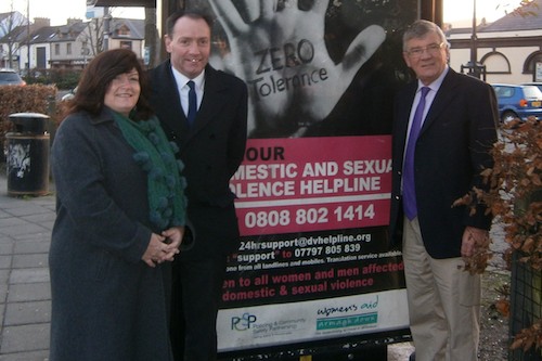Mayor Cllr Michael Ruane with Eileen Murphy,CEO, Women's Aid, Armagh & Down and Cllr Michael Carr, Chair, Policing and Community Safety Partnership at one of the Advertising points in Warrenpoint.