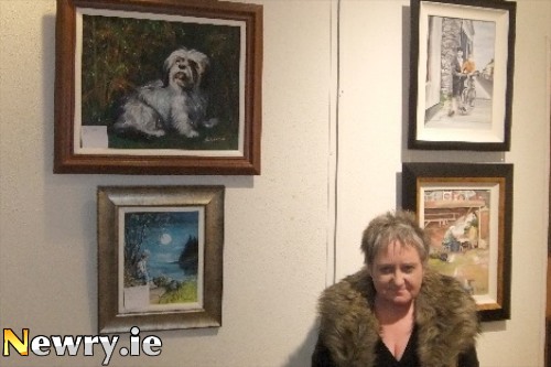 Maria Watson with a selection of her late husband Frank's Paintings on show in the Sean Hollywood Arts Centre.