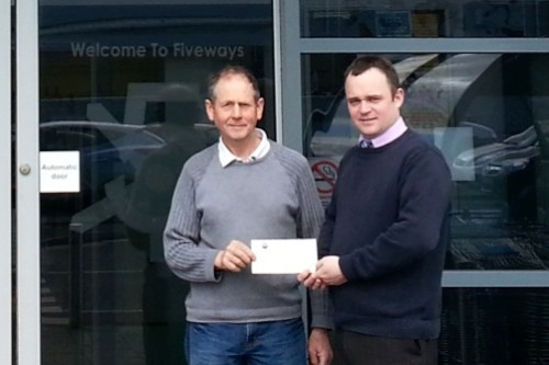 Brian O'Hare, Vice Chairman, Saval Lourdes Invalid Fund receives a cheque from Declan Burns, Assistant Manager, Fiveways, Newry.