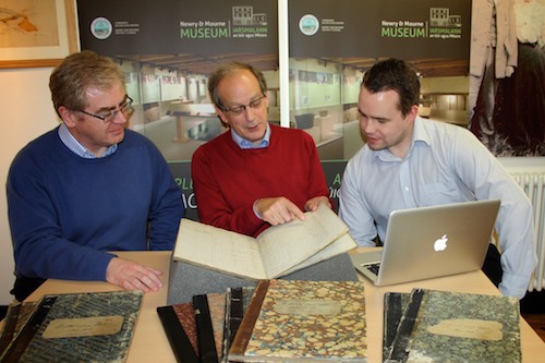 Dr. Ken Abraham, Anthony Russell, and Shane McGivern, look over the Rentals documents at Newry Museum.