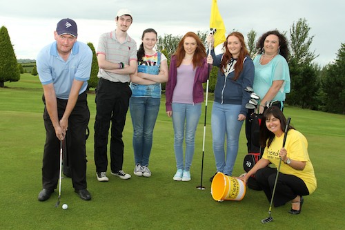 Paul Burns (far left) is pictured practicing his putt ahead of the charity golf day at Mayobridge GC, while being cheered on by (from left) his son Rory; his daughters Colleen, Niamh and Caitlin; his wife Amanda; and Friends of the Cancer Centre's Claire McAuley.