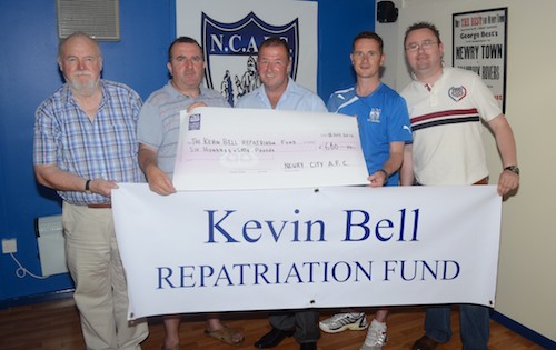 Damian Ruddy (second left) accepts a cheque for £660 on behalf of The Kevin Bell Repatriation Fund from Newry City AFC representatives Tom O Hanlon, Martin McLoughlin, Darren Mullen and Gary Wilson after the recent match with Cliftonville FC. Photograph: Brendan Monaghan.