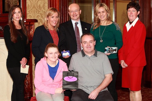 Joe Temple and his daughter Aoife are pictured receiving shopping vouchers from Berling, Lauren McChesney from Cahill Brother Shoes, Orla Sloan from The Quays and Peter Murray from Buttercrane Shopping Centre as well as Gemma Murphy from Jack Murphy Jewellers and Louise Young from the Canal Court Hotel who sponsored the overnight stay.