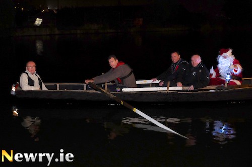 Valuable Cargo! - Santa tries out the Currach for size on the Albert Basin accompanied by Mayor Michael Ruane, James McAreavey, Newry Maritime Association; Thomas McCann, Warrenpoint Heritage, Education and Culture Collective and Dermot Russell, Newry and Mourne District Council. Photograph: Columba O'Hare 