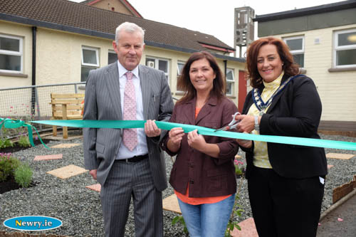 Cllr Gillian Fitzpatrick, Chairperson, Newry, Mourne and Down District Council cuts the tape to officially open the Sensory Garden at St Patrick's Primary School. Looking on are Ciaran Mackin, Principal and Michelle Hanna, Chairperson, Friends of St Patrick's. Photograph: Columba O'Hare