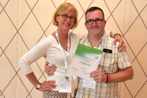 Riitta Mustonen from IFAJ presents Chris McCullough with his award for the best photo.