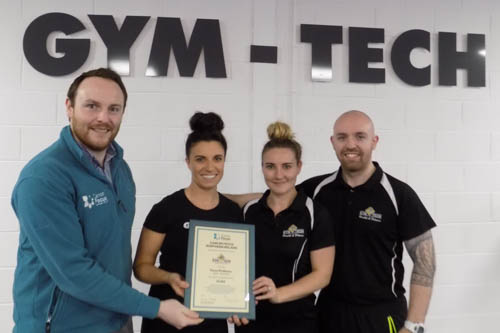 Cancer Focus NI Community Fundraiser Eoin Treanor is seen presenting Gym-Tech Newry trainers Laura Mc Keown, Carla King and Gary Mallon with a plaque as a thank you for their time and efforts during Focus Fit Newry which raised £7,200 for Cancer Focus NI.  