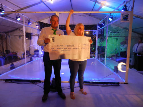 Mary Toner, winner of The Qube, receives her cheque from Shane O’Neill’s chairman Mick Mackin