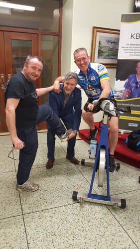 I’m going back on the bicycle! - Former councillor Pat McGinn gets a leg up from Mickey Brady MP and seasoned runner/ cyclist Conor Murphy, MLA.