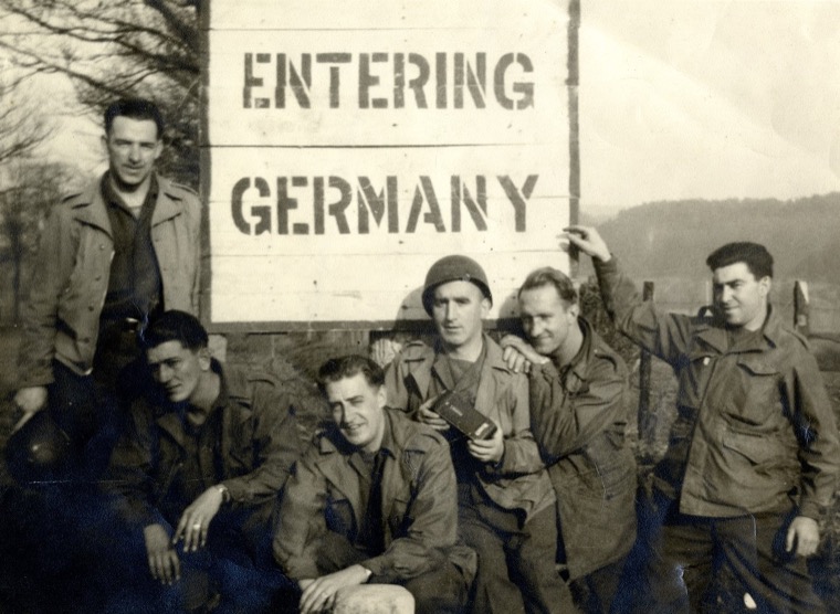 Third from right and holding a camera, James Quinn is seen here with his army comrades as they enter Germany in the late autumn of 1944.  Newry and Mourne Museum Collection