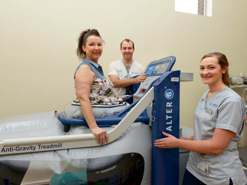 Donal Ferris, Advanced Clinical Specialist Physiotherapist and Natalie Simpson, Physiotherapy Assistant with Jennifer Spence who has used the antigravity treadmill to help her walk again following a fracture.