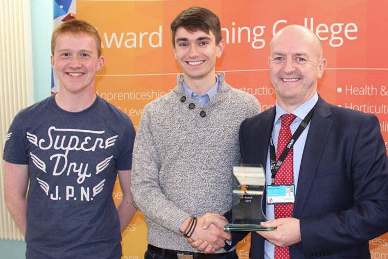 Paul Lyons and Ronan McGibbon from Newry accepting the Engineering Award from Raymond Sloan Director of Client Services at SRC.