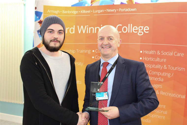 Joshua Cummins from Crossmaglen accepting the Software award for team ‘Rock Bottom’ from Raymond Sloan Director of Client Services at SRC.