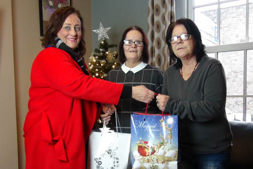 The Chairperson of Newry Mourne and Down District Council, Councillor Gillian Fitzpatrick, presents some Christmas gifts to Margaret and Sally from Simon Community, Newry.