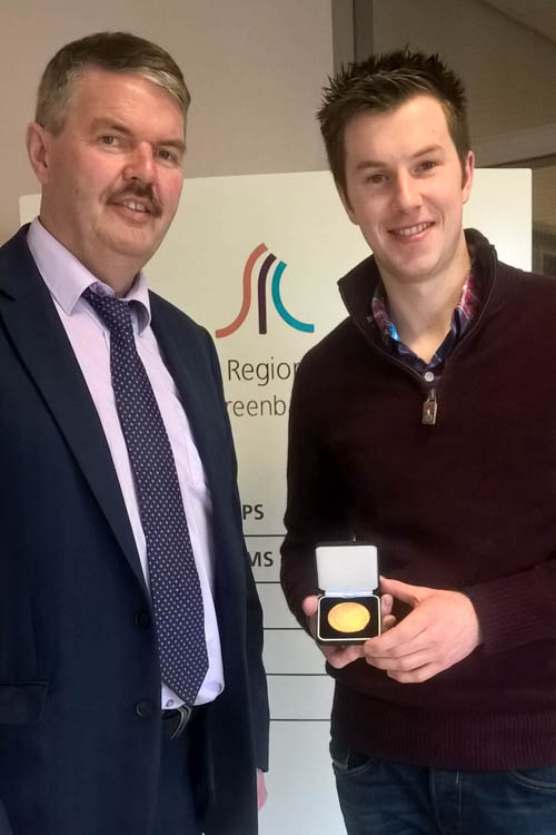 SRC Deputy Head of School Construction and Engineering John Muckian presenting Gary Doyle with his gold medal.