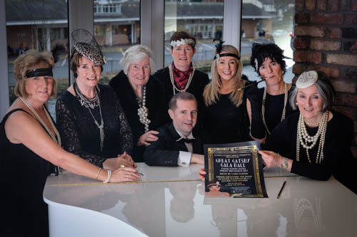 Some of the Dance Committee members are pictured at the launch of the event with Louise Young from the Canal Court Hotel wearing some Great Gatsby headwear and pearls from Accessories by Elite.  Photographed from left to right: Mairead McLoughlin, Geraldine Loughran, Irene Holland, Louise Young, Grainne Mulgrew, Petrina Flood, Patricia Freeman and Eoin Tipping seated at the Piano. Photograph: Columba O'Hare