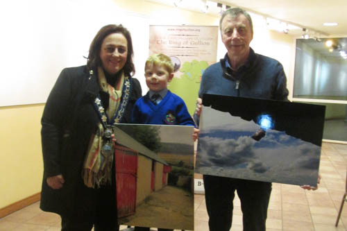 Newry, Mourne and Down District Council Chairperson Councillor Gillian Fitzpatrick congratulates under 14 category winner Danny Murchan and over 14 category winner Patrick Warwick with their entries into Ring of Gullion Photography Competition 2016.