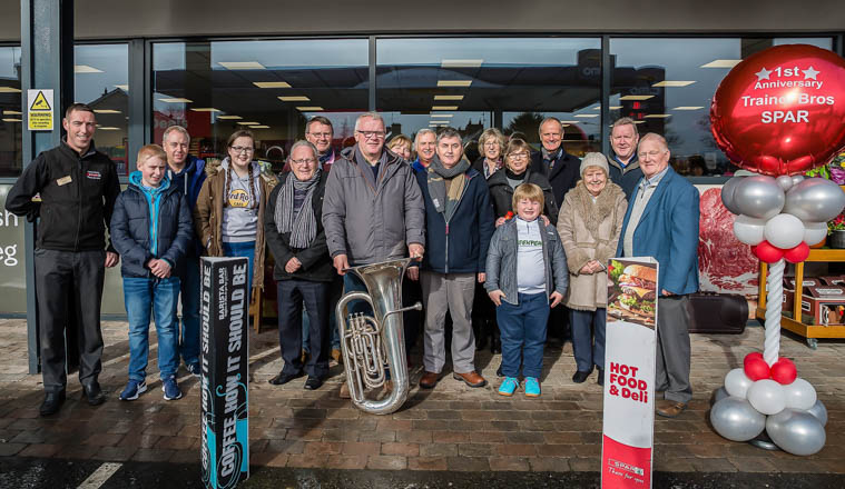 Store Manager, Barry Matthews with, Poyntzpass Silver Band at the celebrations. Photograph: P.Hughes/ LiamMcArdle.com