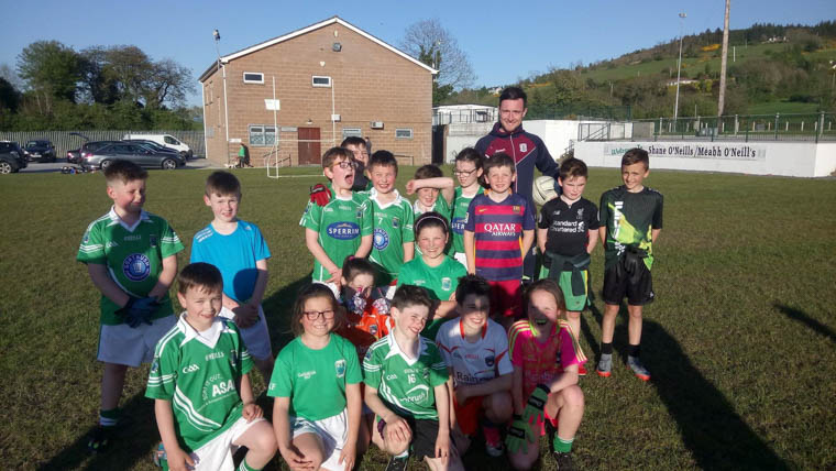 Sport NI’s Thomas McStravick taking a coaching session with some of the Shane’s U10 footballers