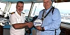 Seadream II Captain Michael Macleoud and Newry Mourne & Down District Council Chairperson Glyn Hanna exchange plaques.