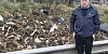 Cllr Aidan Mathers points out some of the litter at the side of the A1