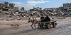 Amid the massive destruction in Jabalia camp, a young man and his mother drive a cart through the camp's streets. Photograph: Mohammed Ibrahim/ Unsplash