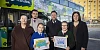 Ruby and Cassy, two winners of Translink's Brand A Bus art competition, pictured in front of the branded bus at Newry Bus Station with family members. Also included is Ruairi McGivern, Senior Inspector, Translink.